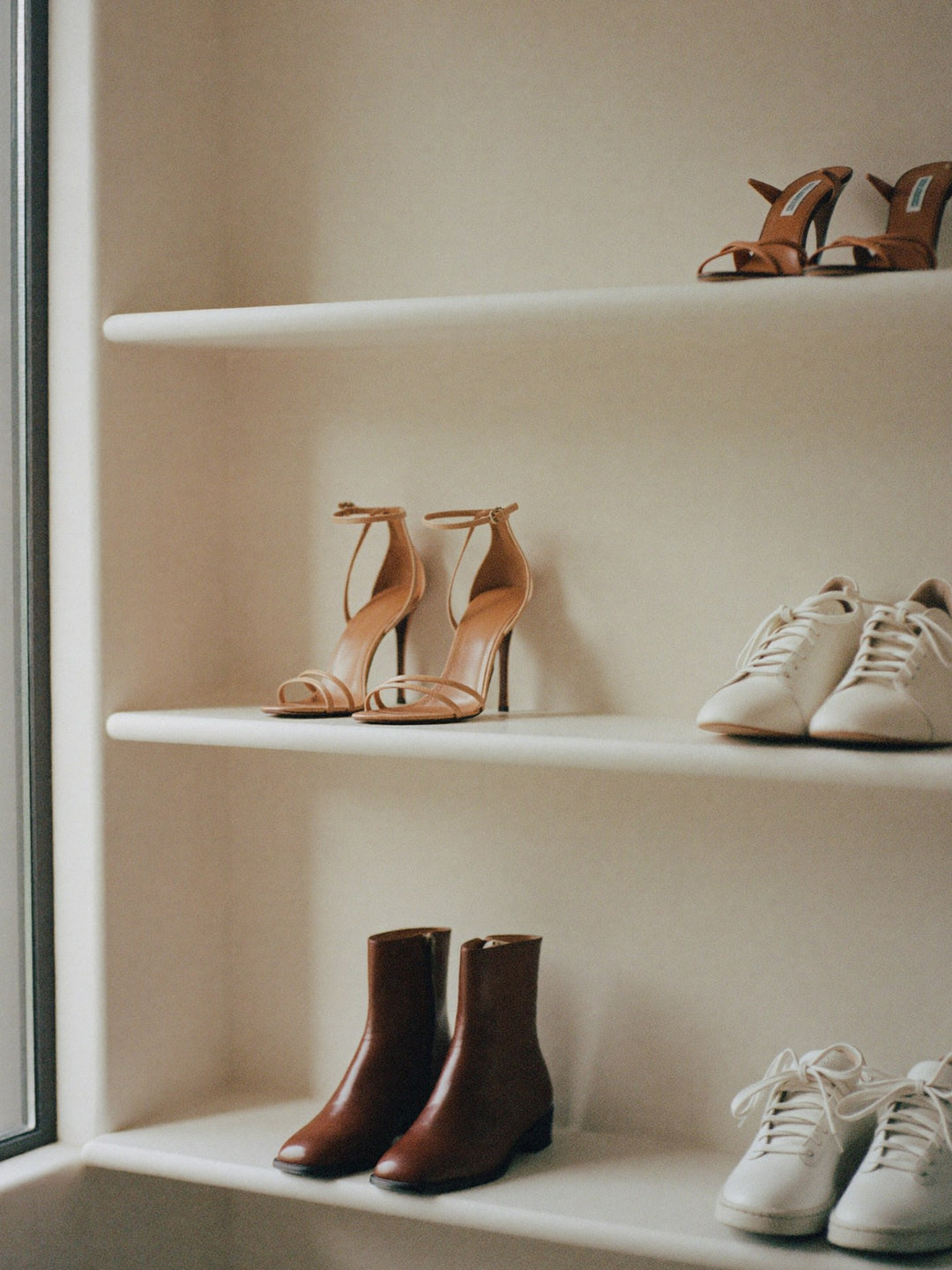 Boutique shelves displaying heels, sneakers and ankle boots